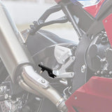 Close-up of motorcycle foot peg and exhaust system on a red sport bike
