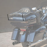 Black touring motorcycle rear with chrome luggage rack, dual antennas, and LED lights