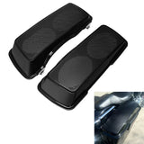 Black motorcycle saddlebag speaker lids with perforated grills, installed on a bike
