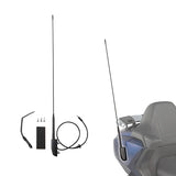 Motorcycle radio antenna kit with mounting hardware and cable, installed on blue bike saddle