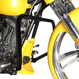 Black engine guard mounted on yellow motorcycle with chrome front wheel