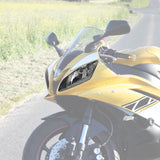 Yellow sport motorcycle with black headlight on a rural road
