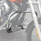 Chrome motorcycle engine guard crash bar mounted on front frame, asphalt background