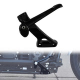 Black motorcycle kickstand side view with part installed on a bike in background