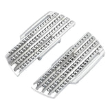 Pair of chrome motorcycle foot pegs with textured, studded surface on white background