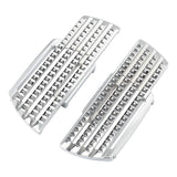 Pair of chrome spiked motorcycle foot pegs with diamond-cut design on white background