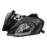 Black automotive headlight assembly with clear lens on white background