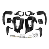 Black plastic ATV fender flares kit with hardware, laid out on white background