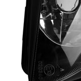 Close-up of a glossy automotive headlight lens showing certification markings.