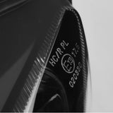 Close-up of automotive headlight lens with E13 certification marking