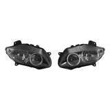 Pair of black automotive projector headlights with clear lenses on white background