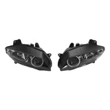 Pair of black projector motorcycle headlights on white background