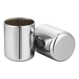 Two stainless steel shot glasses with a polished, reflective finish on a white background.