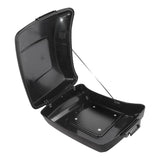 Open black motorcycle top case with latch, empty interior, and metal hinge
